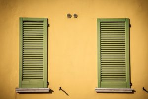 A pair shutters for windows from the outside closed over the window opening